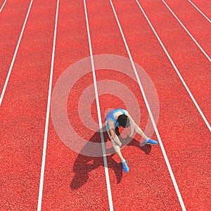 Top view of a defeated athlete on running track