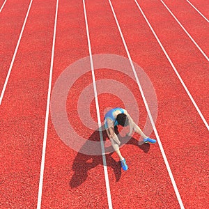 Top view of a defeated athlete on running track photo