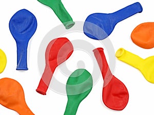 top view of deflated colorful balloons on white background