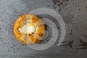 Top view of a delicious cream cheese danish on a gray mottled tabletop