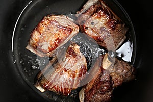 Top view of delicious pork ribs in modern multi cooker