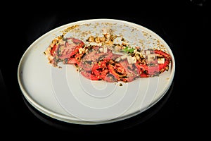 top view on delicious sliced tomato decorated with assorted herbs