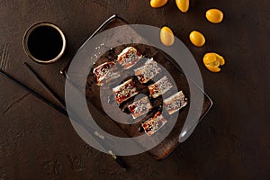 Sushi rolls with eel, cream cheese, kumquats and unagi sauce photo
