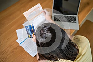 Top view of Depressed desperate Asian girl feel worry about financial problem in house. Stressed young woman look frustrated to