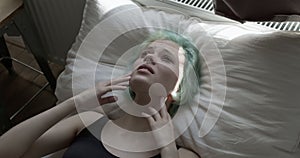 top view on depressed woman lying alone on bed feeling afraid or depressed, copy space