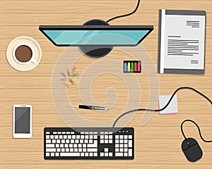 Top view of a desk background. There is a computer, smart phone, gray folder, stationery and cup of coffee