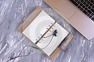 Top view on the desktop gray desk is a notebook diary headphones pen photo