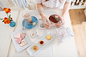 Top view of dessert, cakes, cookies and latte on table