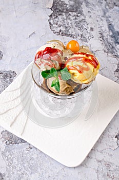 Top view of Dessert - Three balls of multi flavor ice cream with Scoops of Chocolate, Vanilla and Fruit Ice Cream with