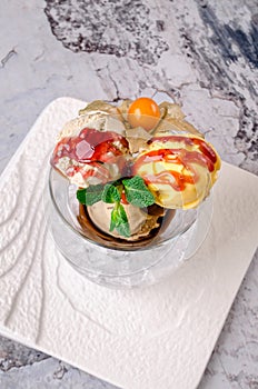 Top view of Dessert - Three balls of multi flavor ice cream with Scoops of Chocolate, Vanilla and Fruit Ice Cream with