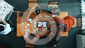 Top view of developer team working together to write idea on board. Convocation.