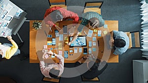 Top view of developer team working together to write idea on board. Convocation.