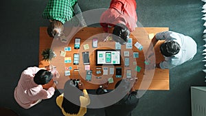 Top view of developer team working together to write idea on note. Convocation.