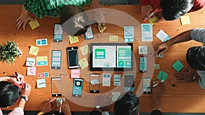 Top view of developer team working together to write idea on note. Convocation.