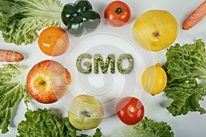 Top view different GMO fruits and vegetables arranged on the table. Non organic food dangerous nutrition for human health. Fresh