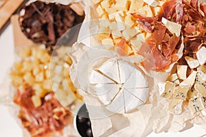 Top view of different kinds of cheese and meat on table