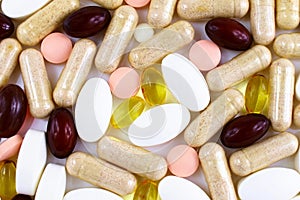 Top view of different medical pills and nutritional supplements texture close up.