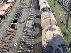 Top view of different railway wagons and tanks on an industrial railroad with rails for the transport of goods and improved modern