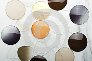 Top view of different shapes of corrective lens on the white surface