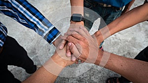 The top view of a diverse group of hands together to support teamwork Aerial