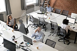 Top view of diverse workers busy working in shared office photo