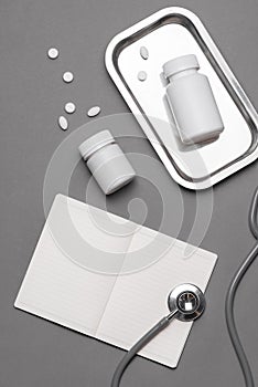 Top view of doctor desk table with stethoscope and medical items