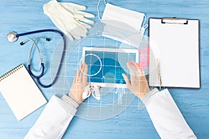 Top view of doctor hands with tablet computer