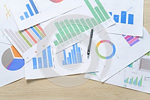 Top view of Documents with analytics data lying on table,selective focus