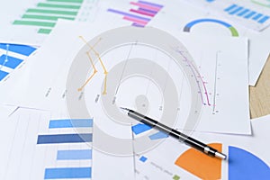 Top view of Documents with analytics data lying on table,selective focus
