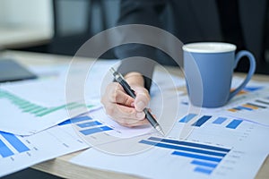 Top view of Documents with analytics data lying on table,selective focus