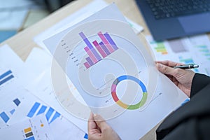 Top view of Documents with analytics data lying on table,selective focus