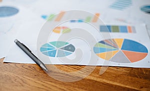 Top view documents with analytics data on table.