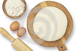 Top view of dough rolling pin wooden bowl eggs isolated on white