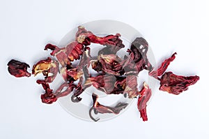 Top view of dried hibiscus petals on the white surface photo