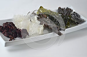 Top view of dried kelp, nori, dulse, wakame, alaria and agar agar seaweed