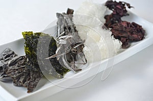 Top view of dried kelp, nori, dulse, wakame, alaria and agar agar seaweed