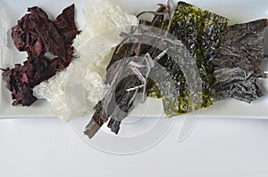 Top view of dried kelp, nori, dulse, wakame, alaria and agar agar seaweed