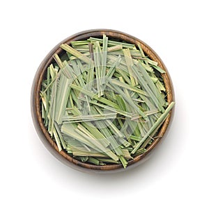 Top view of dried lemongrass herb in wooden bowl