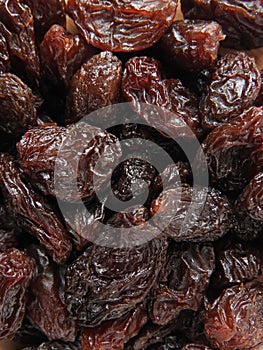 Top view of dried raisins background. Dry food. It tastes sweet and delicious.