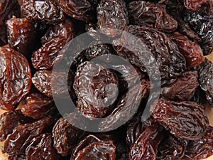 Top view of dried raisins background. Dry food. It tastes sweet and delicious.