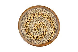 Top view of dried Wheat Berries in wooden bowl. Dry wheat berry