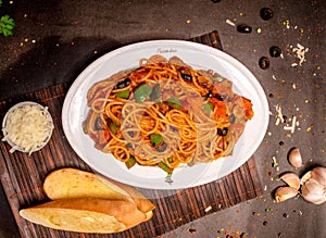 Top view of drunken noodles (Pad Kee Mao) in white plate with two toasted bread and grated cheese