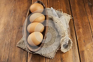 Easter background. Table setting for the holiday of Easter in a rustic style, burlap napkin, eggs, fork and knife on a wooden