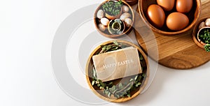 Top view Easter composition with inscription happy Easter and succulent plants in egg shell on white table