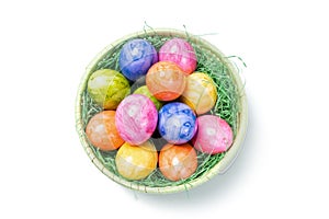 Top View - Easter Eggs in Basket on white