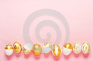 Top view of easter eggs colored with golden paint in differen patterns.