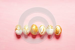 Top view of easter eggs colored with golden paint in differen patterns. Copy space.