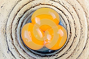 Top view of egg yolks in glasses bowl