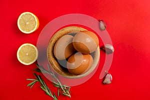 Top view of eggs, lemons and garlic ingredients needed to make the rich homemade alioli sauce typical Spanish sauce