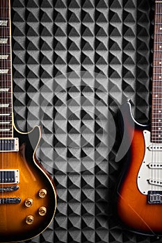 Top view of electric guitar on acoustic foam panel background
